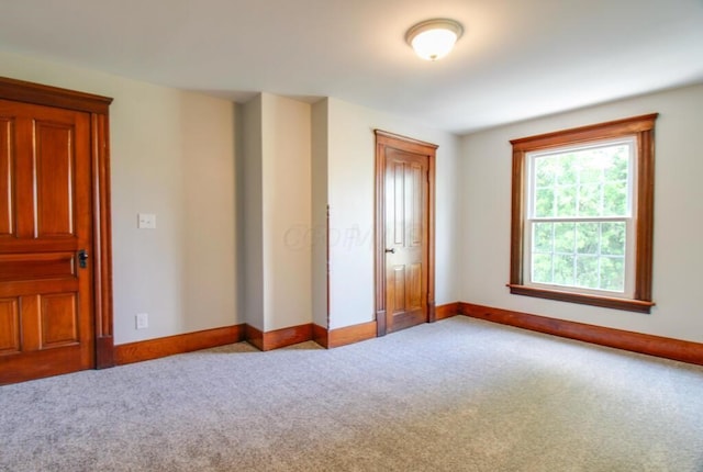 unfurnished bedroom featuring baseboards and carpet floors