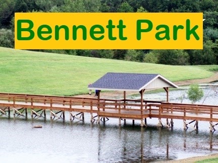 dock area featuring a water view and a lawn