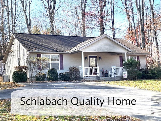 ranch-style house featuring a porch and central AC