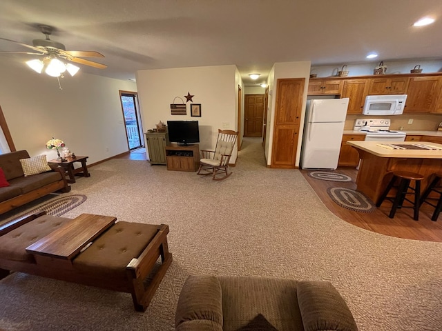 carpeted living room featuring ceiling fan