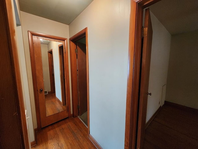 hallway with hardwood / wood-style flooring