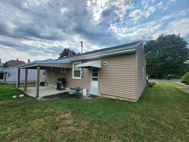 rear view of house with a patio area and a yard