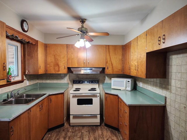 kitchen with white appliances, ventilation hood, sink, dark hardwood / wood-style floors, and ceiling fan