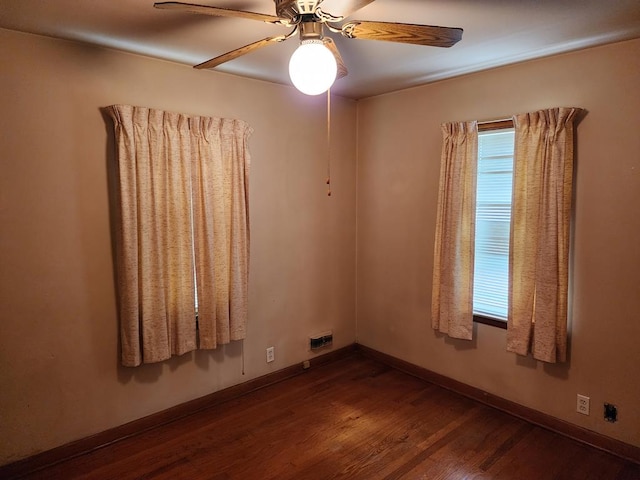 spare room with dark hardwood / wood-style floors and ceiling fan