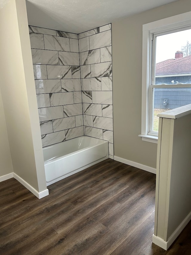 full bathroom featuring wood finished floors, shower / tub combination, and baseboards