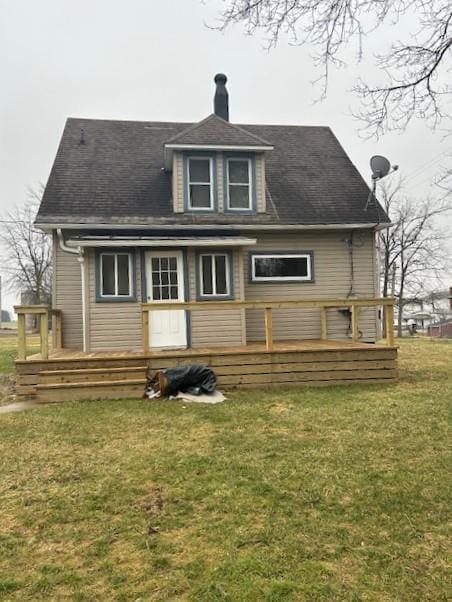 rear view of house featuring a yard and a wooden deck