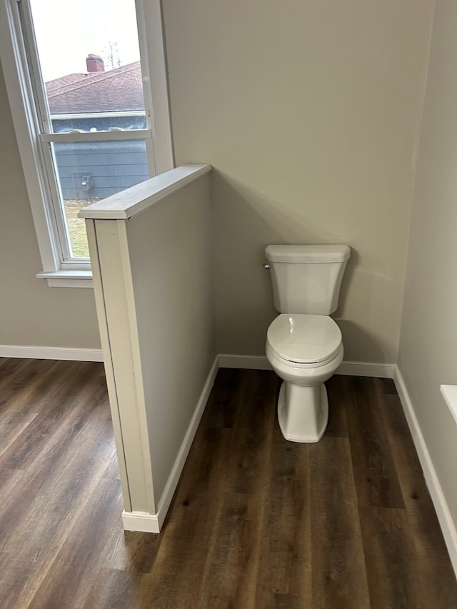 bathroom featuring baseboards, toilet, and wood finished floors