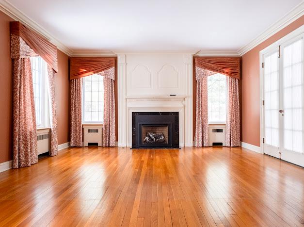 unfurnished living room with radiator heating unit and a wealth of natural light