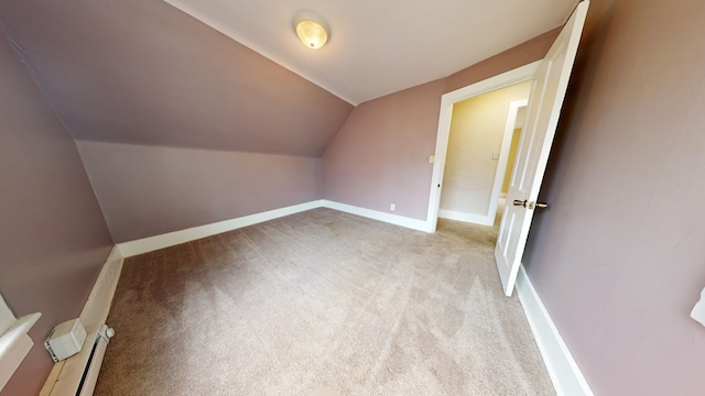 bonus room with lofted ceiling, light colored carpet, and baseboard heating