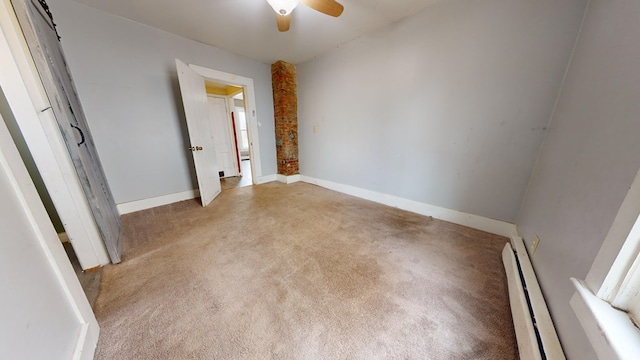 carpeted spare room featuring ceiling fan and baseboard heating