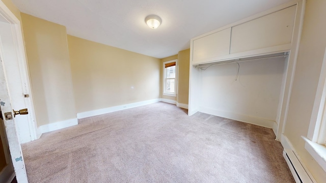 unfurnished bedroom featuring light colored carpet and a closet