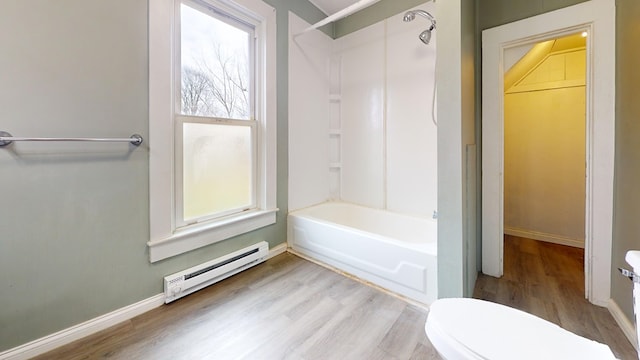 bathroom with hardwood / wood-style floors, a baseboard radiator, toilet, and shower / bath combination