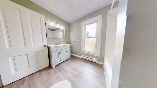 bathroom with a baseboard radiator, wood-type flooring, and vanity