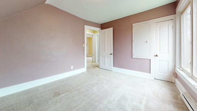 unfurnished bedroom with light carpet and lofted ceiling