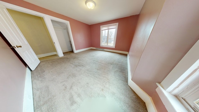 unfurnished bedroom with light carpet and a closet