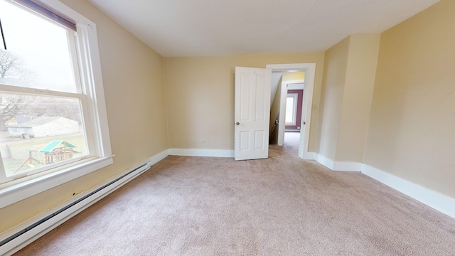 carpeted spare room with a baseboard radiator