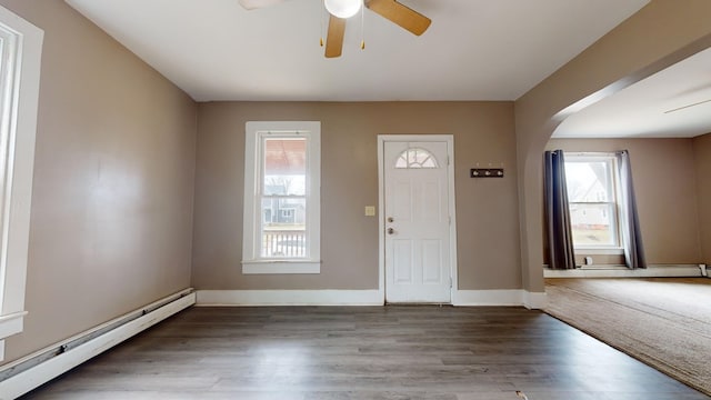 entryway featuring hardwood / wood-style flooring, ceiling fan, and a baseboard heating unit