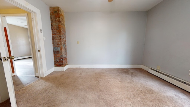 unfurnished room featuring a baseboard radiator and light colored carpet