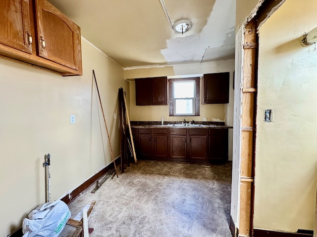 kitchen with baseboards and a sink