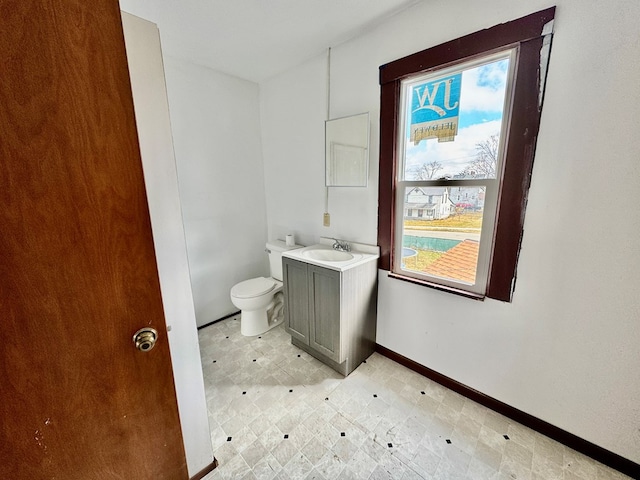 bathroom with vanity, tile patterned floors, toilet, and baseboards