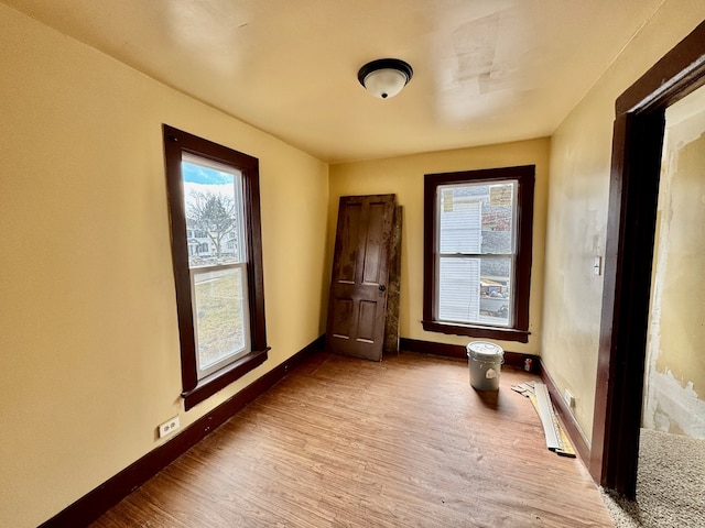 empty room with baseboards and wood finished floors