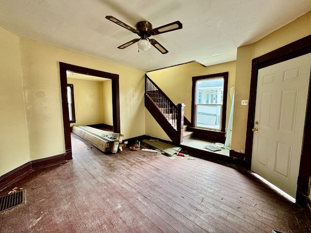 foyer featuring visible vents, stairs, baseboards, and hardwood / wood-style floors