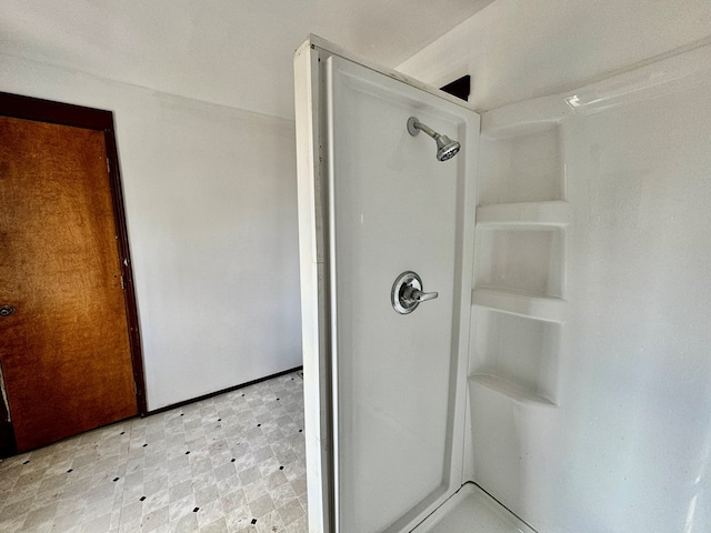 bathroom with tile patterned floors and walk in shower