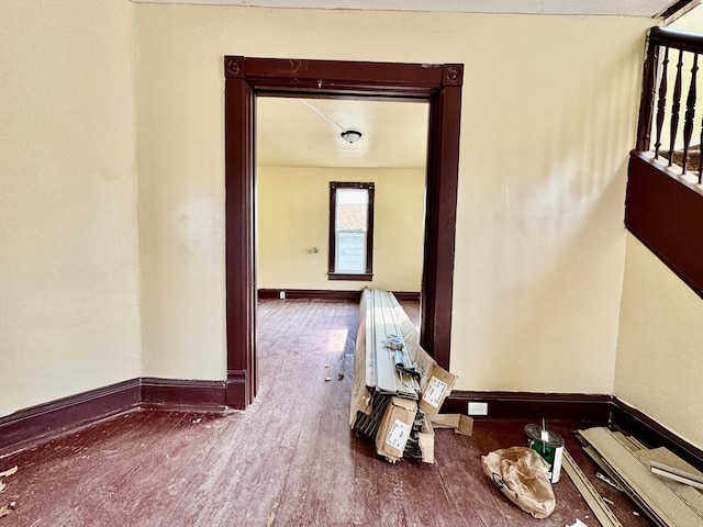 interior space with baseboards and wood finished floors