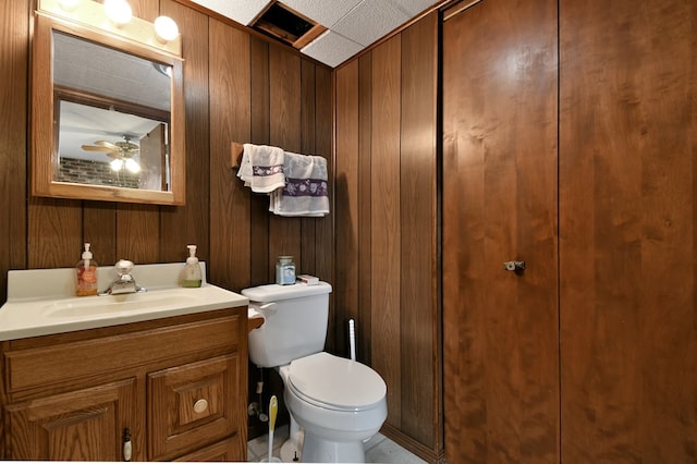 1690 Evergreen Ave W, Mansfield, OH 44905 - kitchen featuring brown cabinetry, ceiling fan, stainless steel appliances, under cabinet range hood, and backsplash