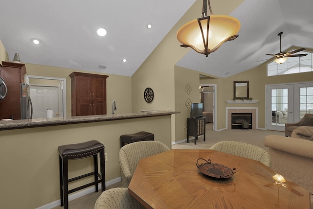 810 Whippoorwill Ln, Mansfield, OH 44906 - dining space featuring lofted ceiling, a ceiling fan, light colored carpet, a fireplace, and recessed lighting