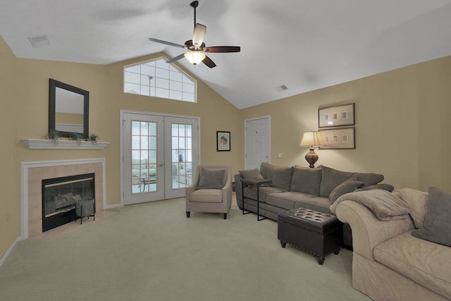 810 Whippoorwill Ln, Mansfield, OH 44906 - carpeted living room with a ceiling fan, french doors, a tiled fireplace, and high vaulted ceiling
