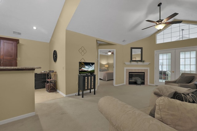 810 Whippoorwill Ln, Mansfield, OH 44906 - living area featuring ceiling fan, light carpet, a tile fireplace, high vaulted ceiling, and french doors