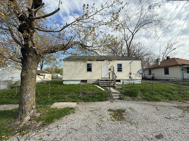 manufactured / mobile home with a front yard, a fenced front yard, a gate, and entry steps