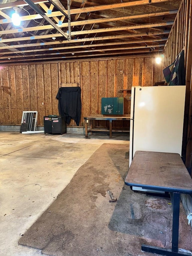 basement with freestanding refrigerator