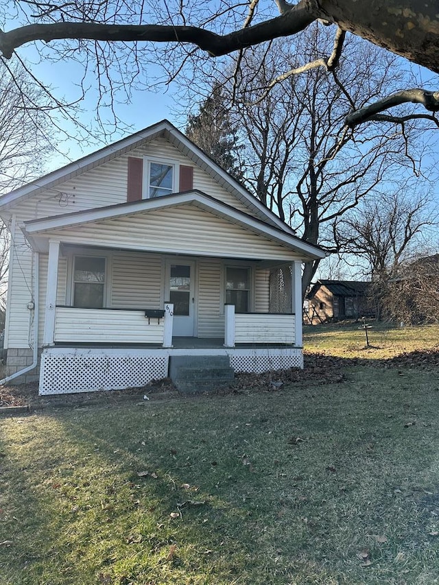 bungalow-style house with a porch and a front lawn