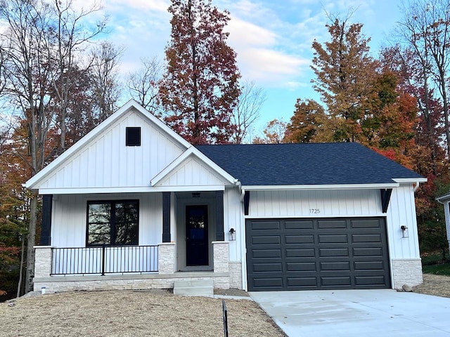 modern inspired farmhouse featuring a garage and covered porch