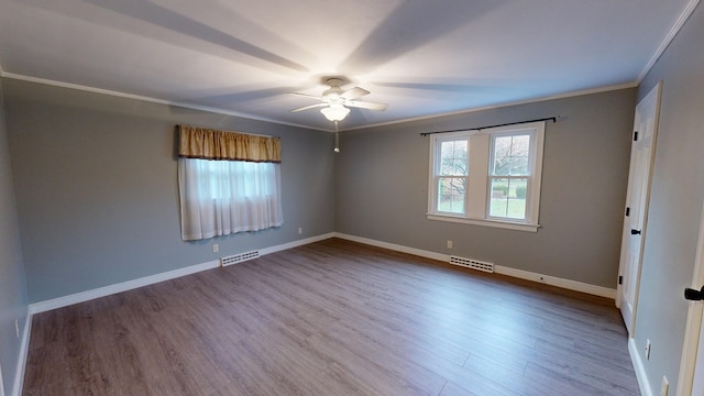 empty room with crown molding, ceiling fan, and wood-type flooring