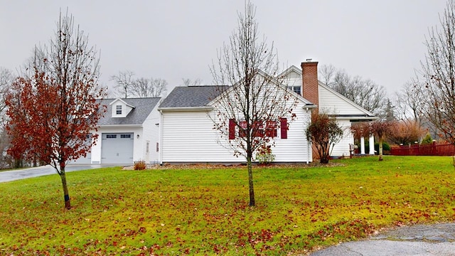 view of property exterior featuring a garage and a yard