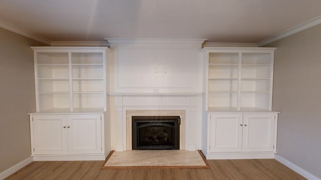 unfurnished living room featuring light wood-type flooring and ornamental molding