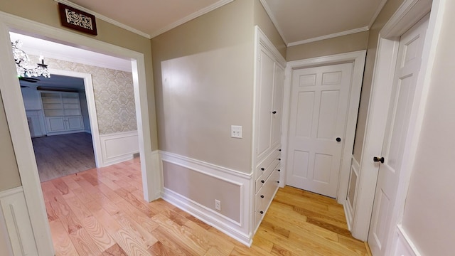 corridor featuring light hardwood / wood-style flooring and crown molding