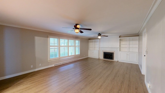 unfurnished living room with baseboard heating, crown molding, and ceiling fan