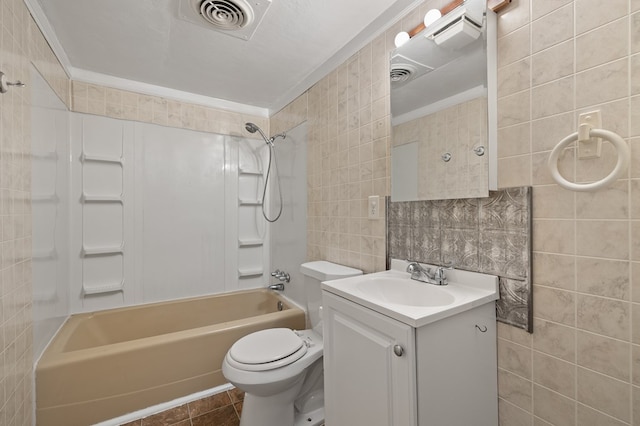 933 Fairfax Ave, Mansfield, OH 44906 - bathroom with tile walls, shower / washtub combination, vanity, toilet, and tile patterned flooring
