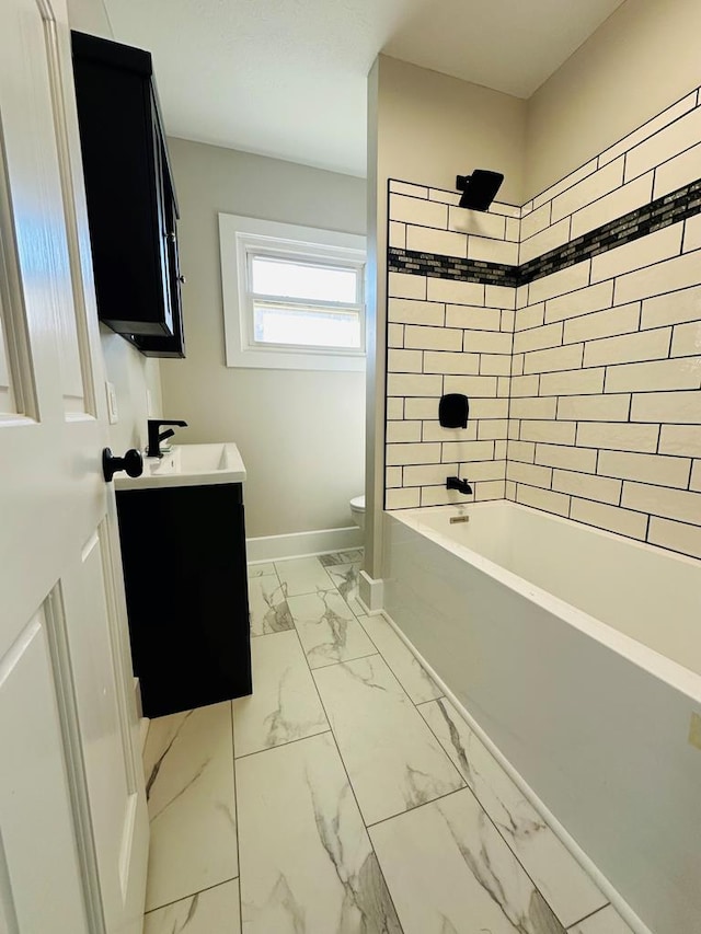 full bathroom featuring vanity, tiled shower / bath combo, and toilet