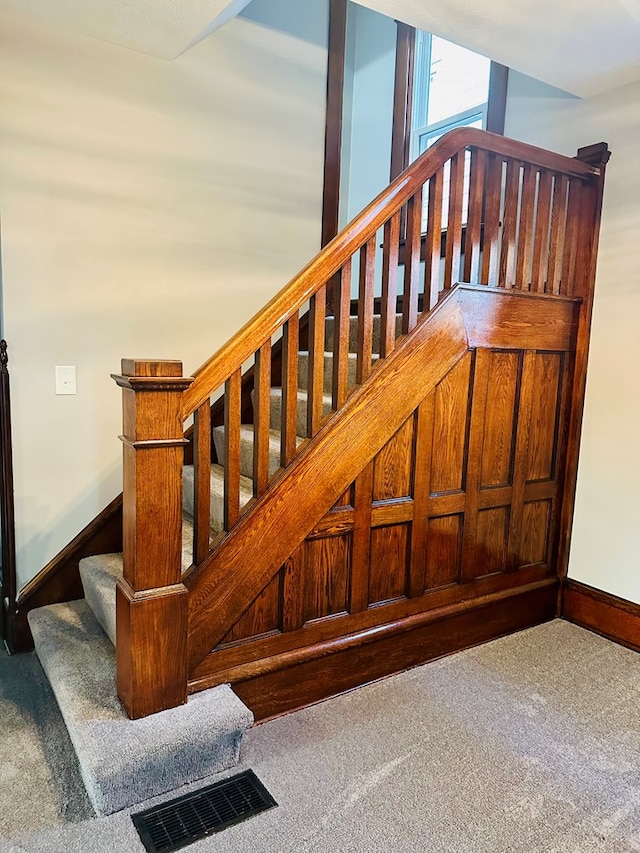 stairs featuring carpet