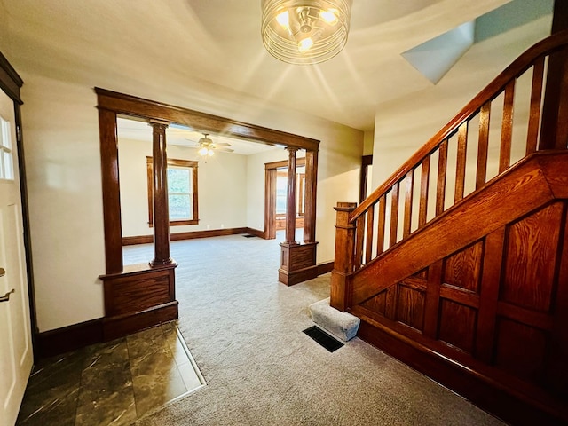 interior space with ceiling fan, carpet floors, and decorative columns