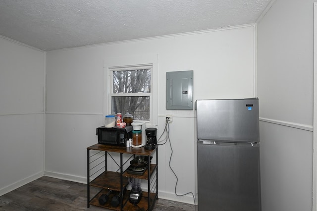 miscellaneous room featuring electric panel, a textured ceiling, baseboards, and wood finished floors