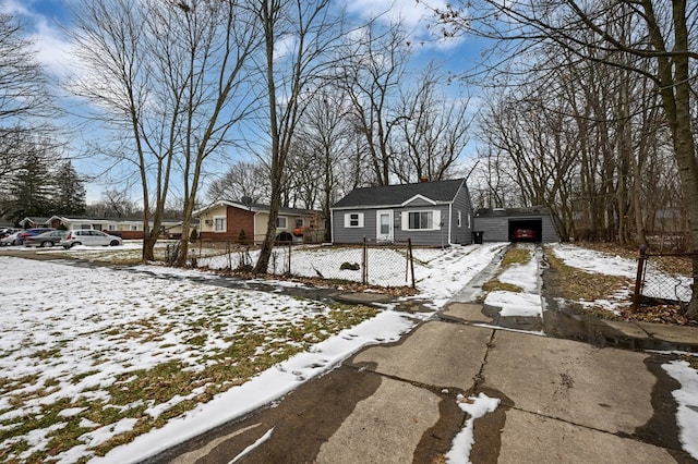 bungalow-style house featuring a garage, fence, a chimney, and an outdoor structure