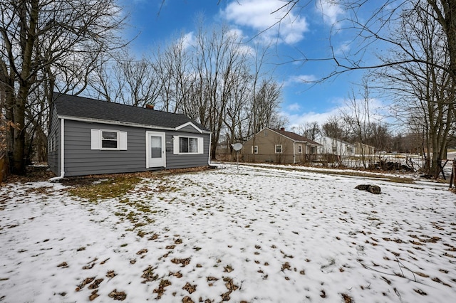 view of front of property featuring a chimney and fence