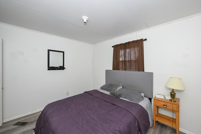 bedroom featuring wood finished floors and baseboards