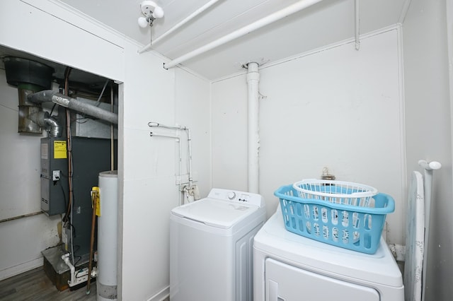 laundry area with laundry area, separate washer and dryer, and wood finished floors